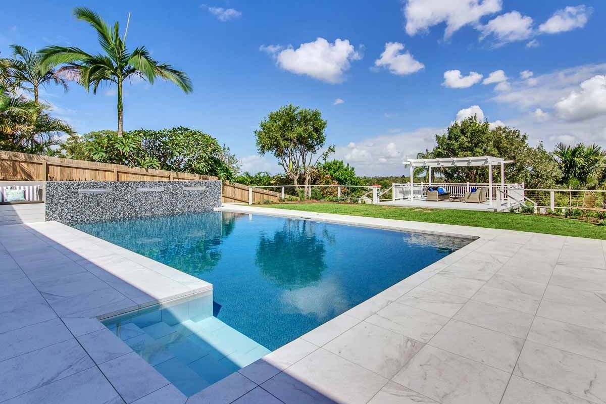 Blue vinyl pool liner for swimming pool and backyard tropical retreat.