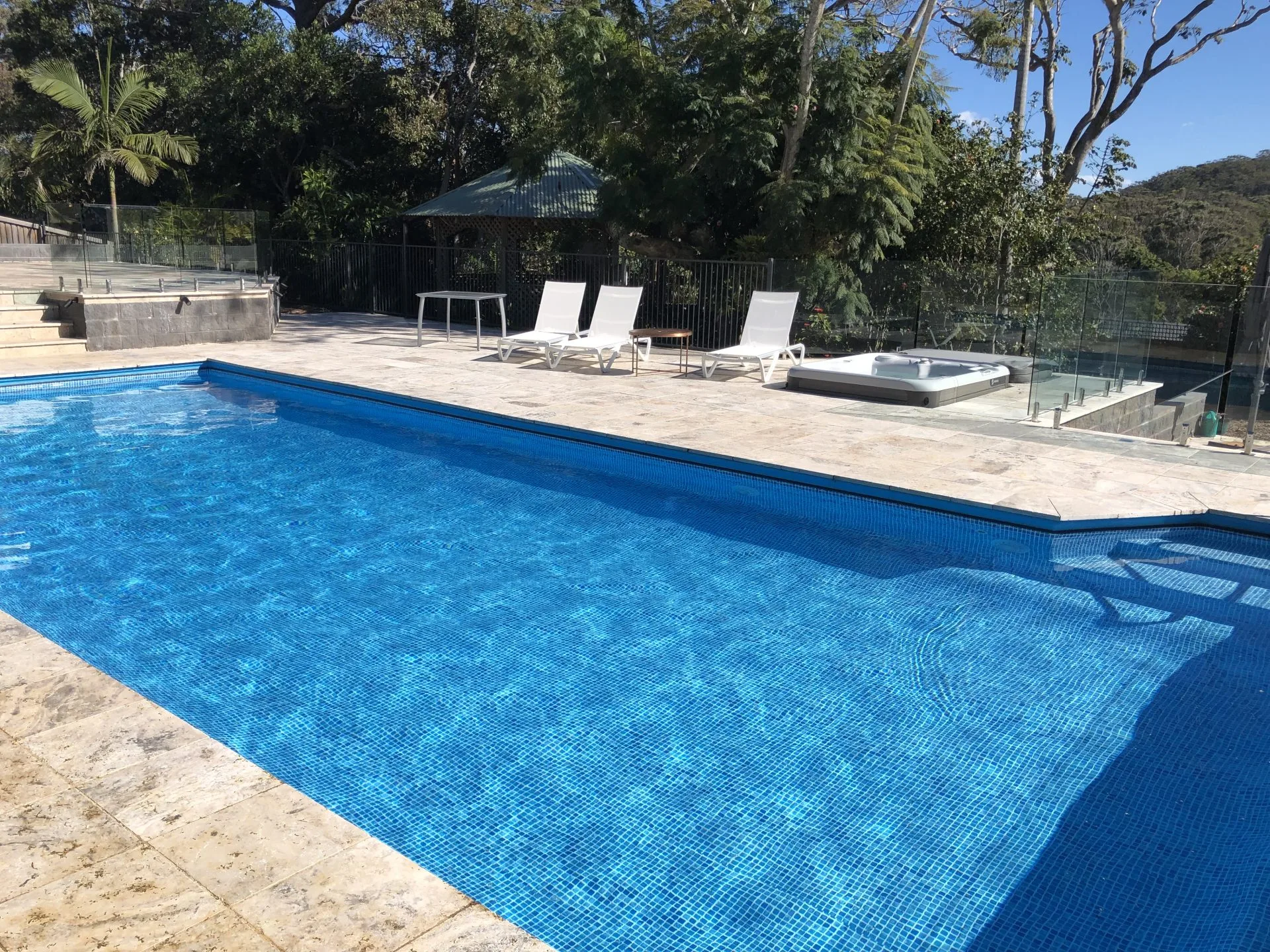 Light coloured vinyl pool liner for bean shaped swimming pool.