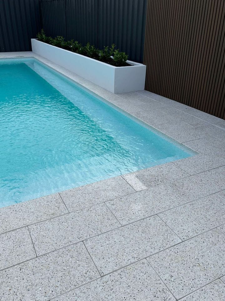 Light coloured vinyl pool liner for bean shaped swimming pool.