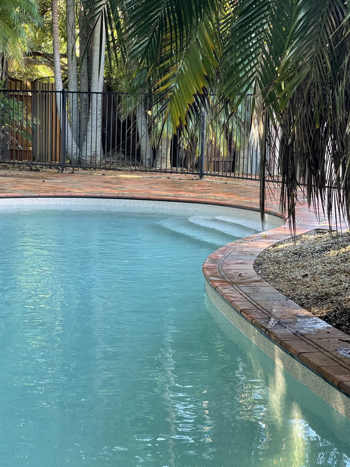 Blue vinyl pool liner for swimming pool and backyard tropical retreat.